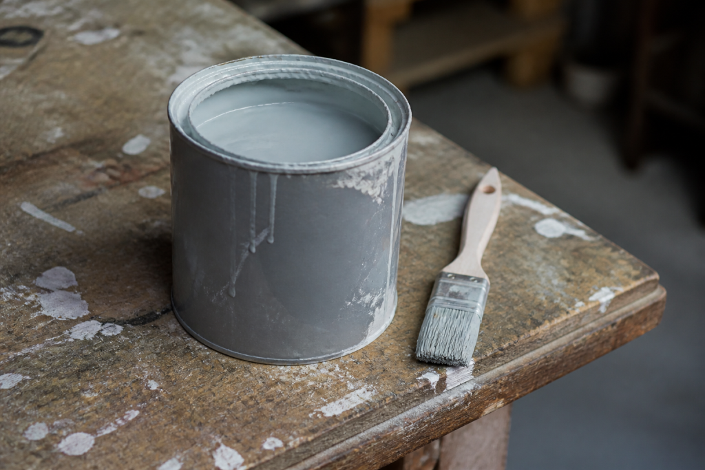 Pot de peinture gris quartz et pinceau sur etabli